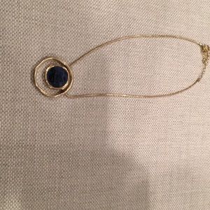 Gold necklace with purple pendant